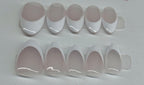 Set of white nail tips on a gray background