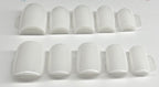 Set of white nail caps on a white background