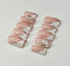 Pair of pink and white heart-shaped earrings on a light gray background