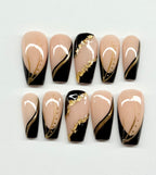 Set of nail art designs with black, gold, and beige colors on a white background