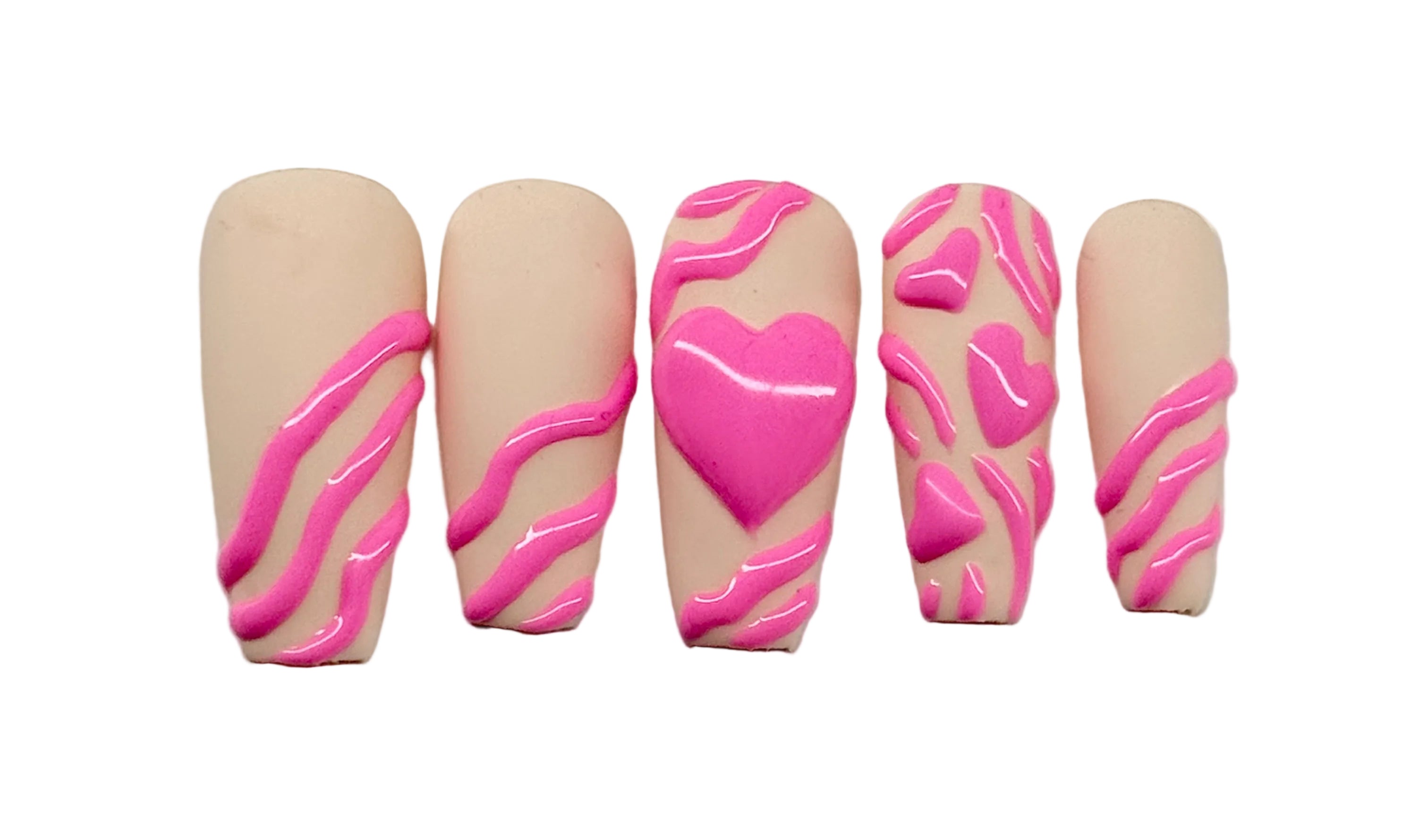 Five artificial nails with pink heart and zebra pattern designs on a beige matte background
