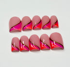 Set of pink and orange nail wraps with gold accents on a white background