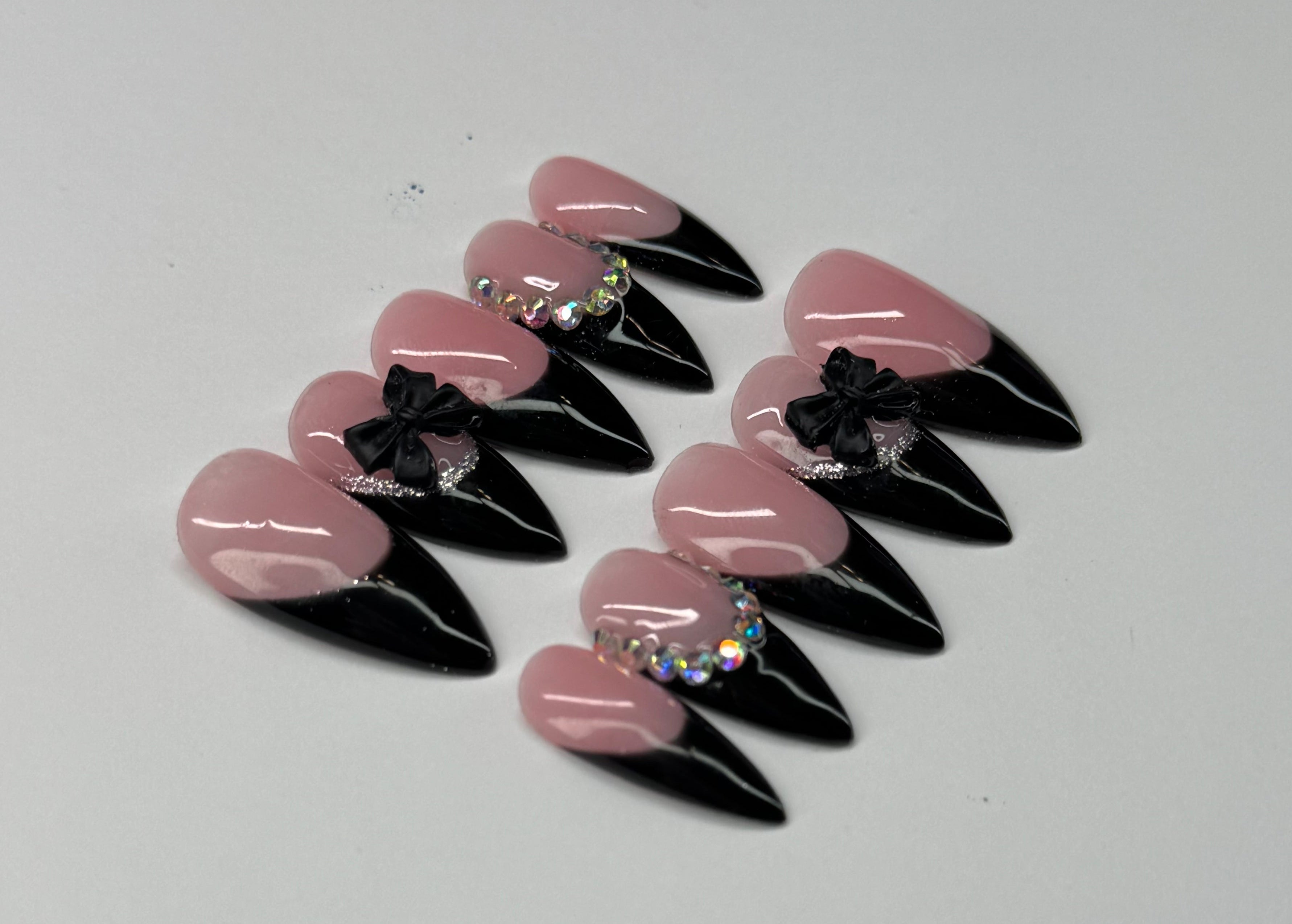 Set of nude base pink and black french tip nail art designs on a white background