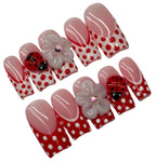 Set of decorative nail art with polka dots and ladybug designs on a white background