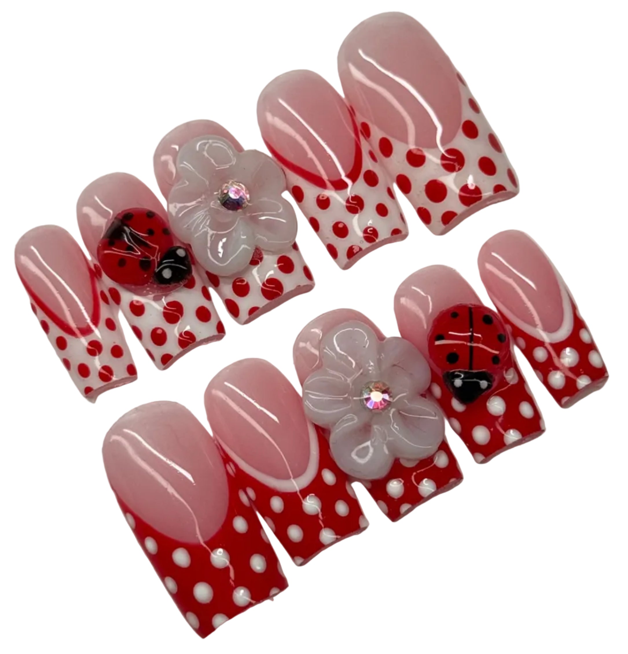 Set of decorative nail art with polka dots and ladybug designs on a white background