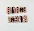 Set of nail art designs with polka dots and bows on a light background