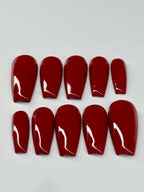 Set of red nail extensions with white tips on a light gray background