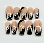 Nail art design with black, gold, and beige colors on a white background