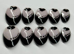 Set of black and white nail art designs on a light gray background