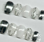 Silver and white beads on a white background