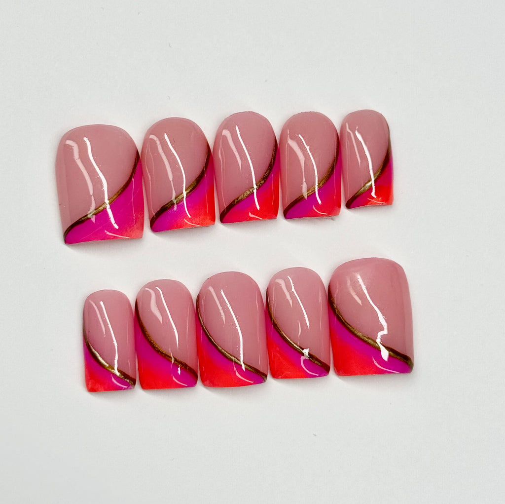 Set of pink and orange nail art with gold accents on a white background