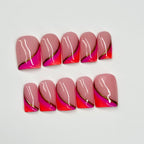Set of pink and orange nail art with gold accents on a white background