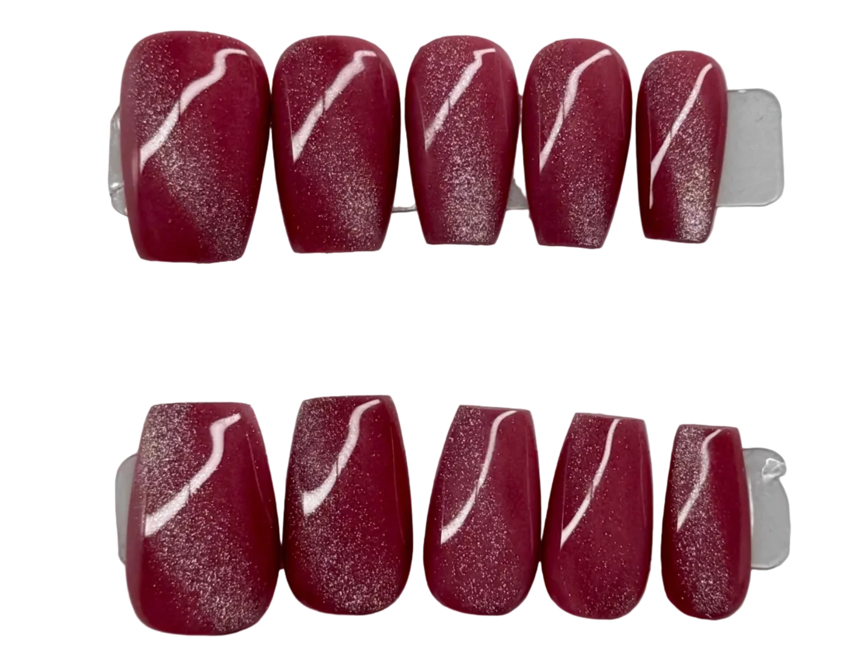 Set of red nail art with white designs on a branded card