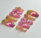 Set of pink and beige nail art designs with decorative elements on a white background