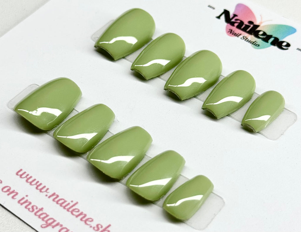 Set of green nail extensions on a clear tray with 'Nailene' branding.