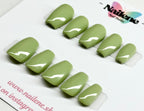 Set of green nail extensions on a clear tray with 'Nailene' branding.