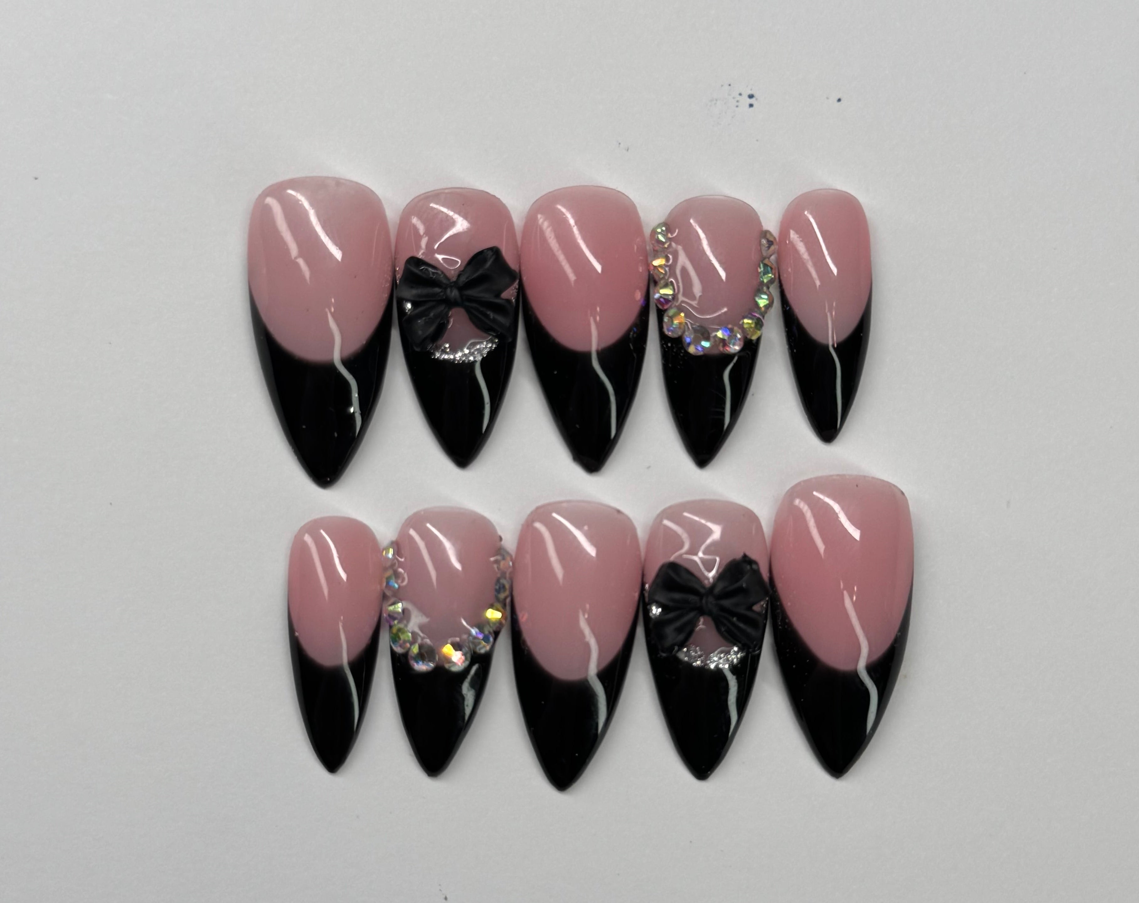 Set of nude pink and black french tip nail designs on a light gray background