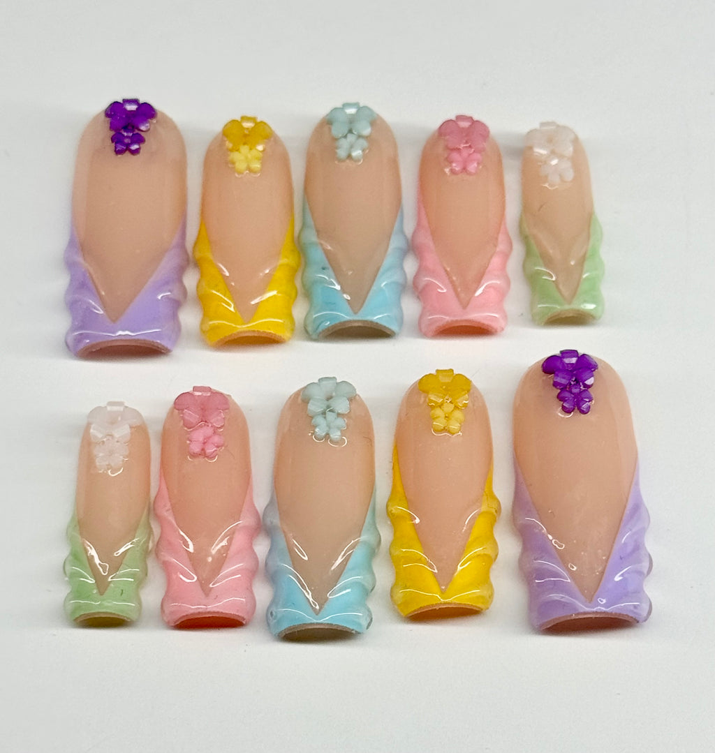 Set of pastel-colored nail art designs on a white background
