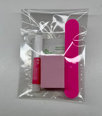 Packaged nail care items including a pink nail file, white box, and red tube on a gray background.