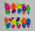Colorful flower-shaped nail art designs on a white background