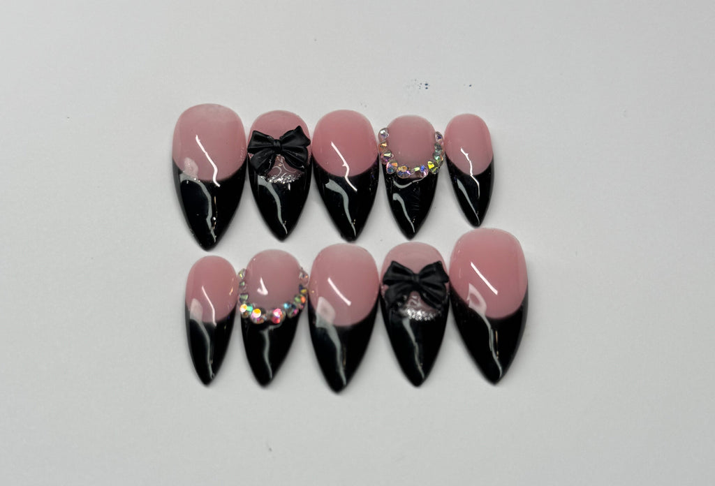 Black french tip and nude pink base nail art designs on a white background