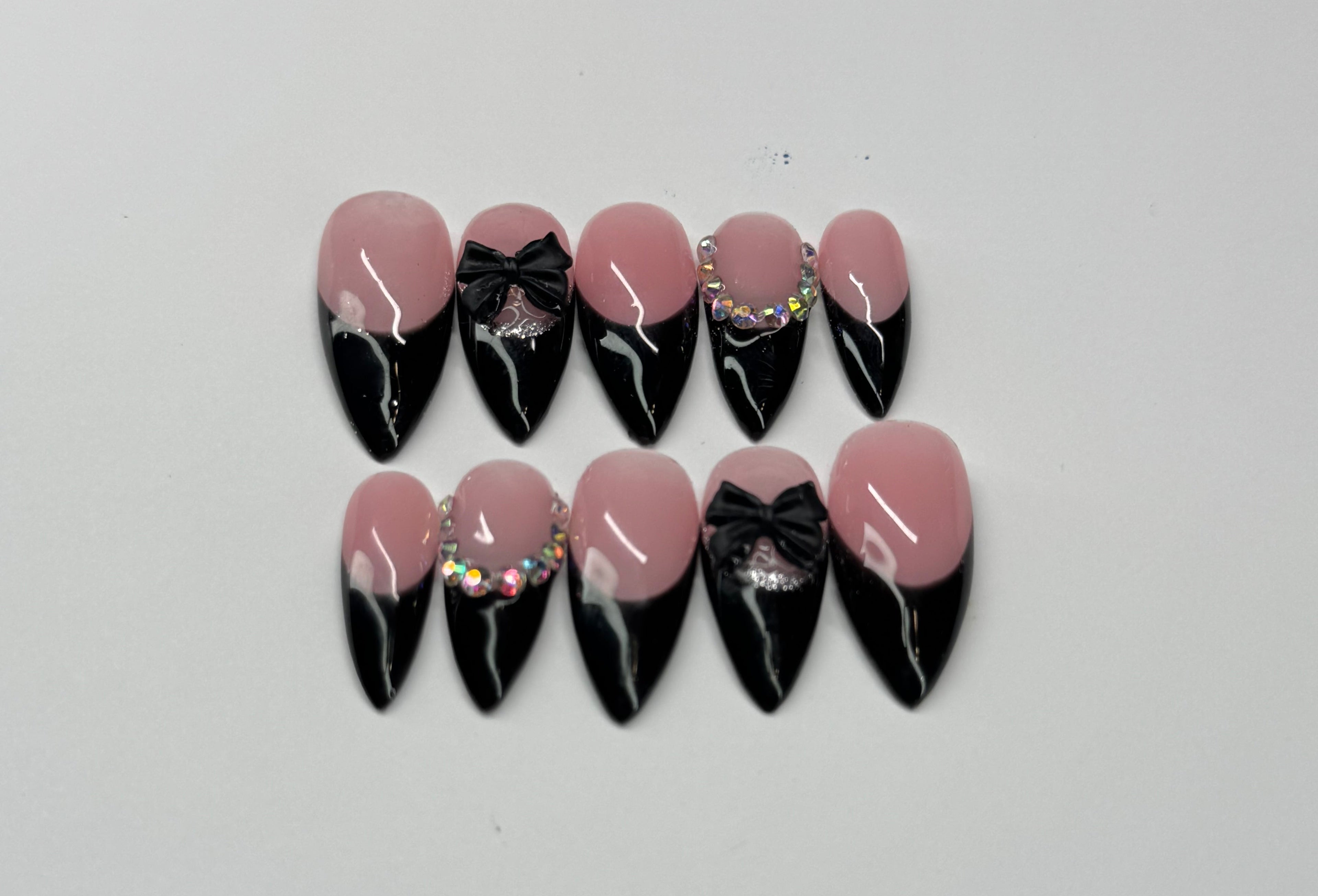 Black french tip and nude pink base nail art designs on a white background