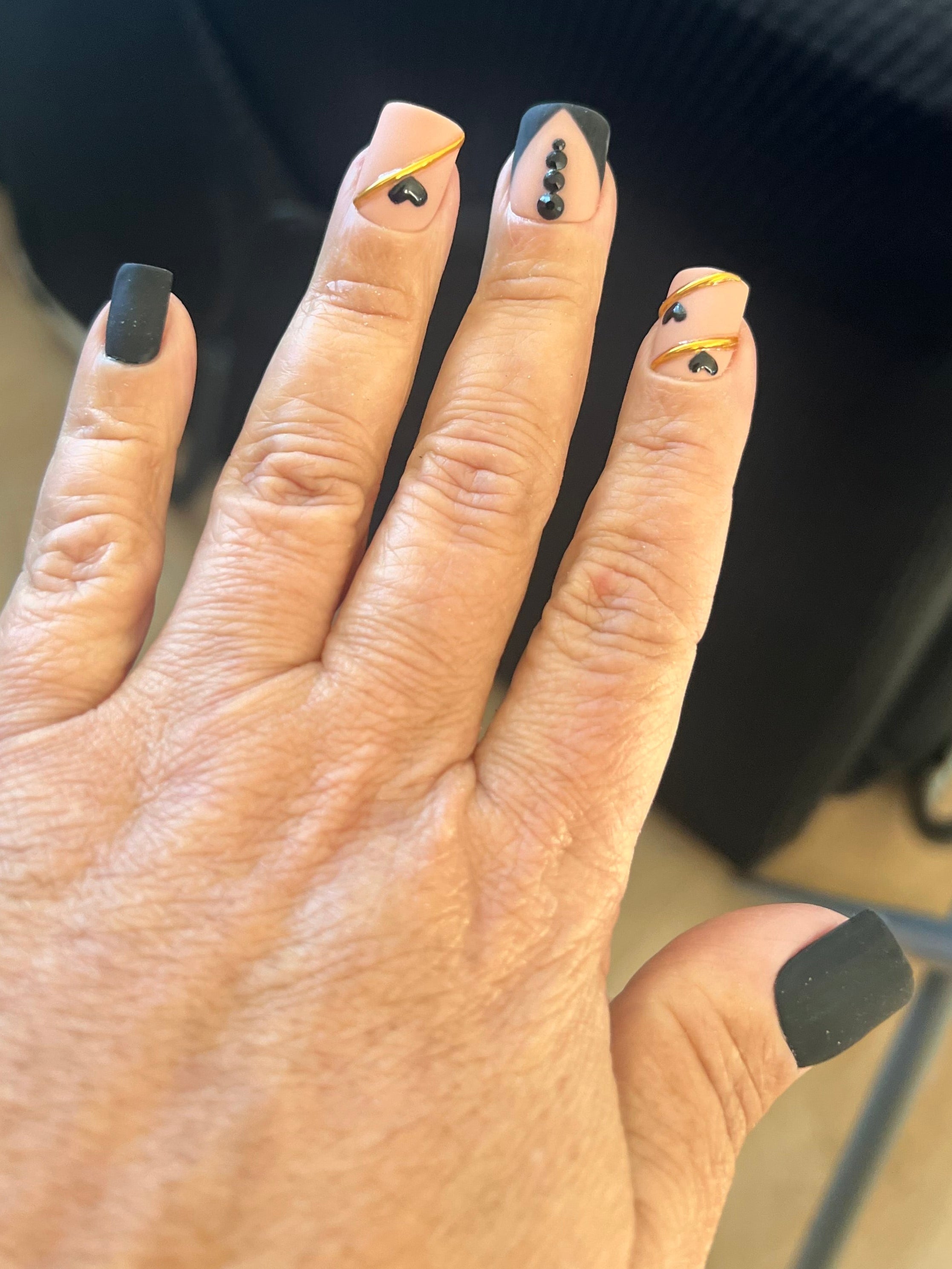 Realistic Hand with black nail polish on a blurred background
