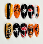 Nail art designs inspired by Naruto with black, orange, and white patterns on a white background.