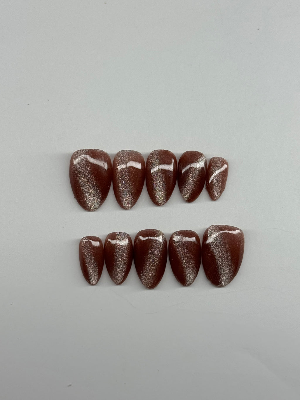 Two stacks of brown stones on a white background