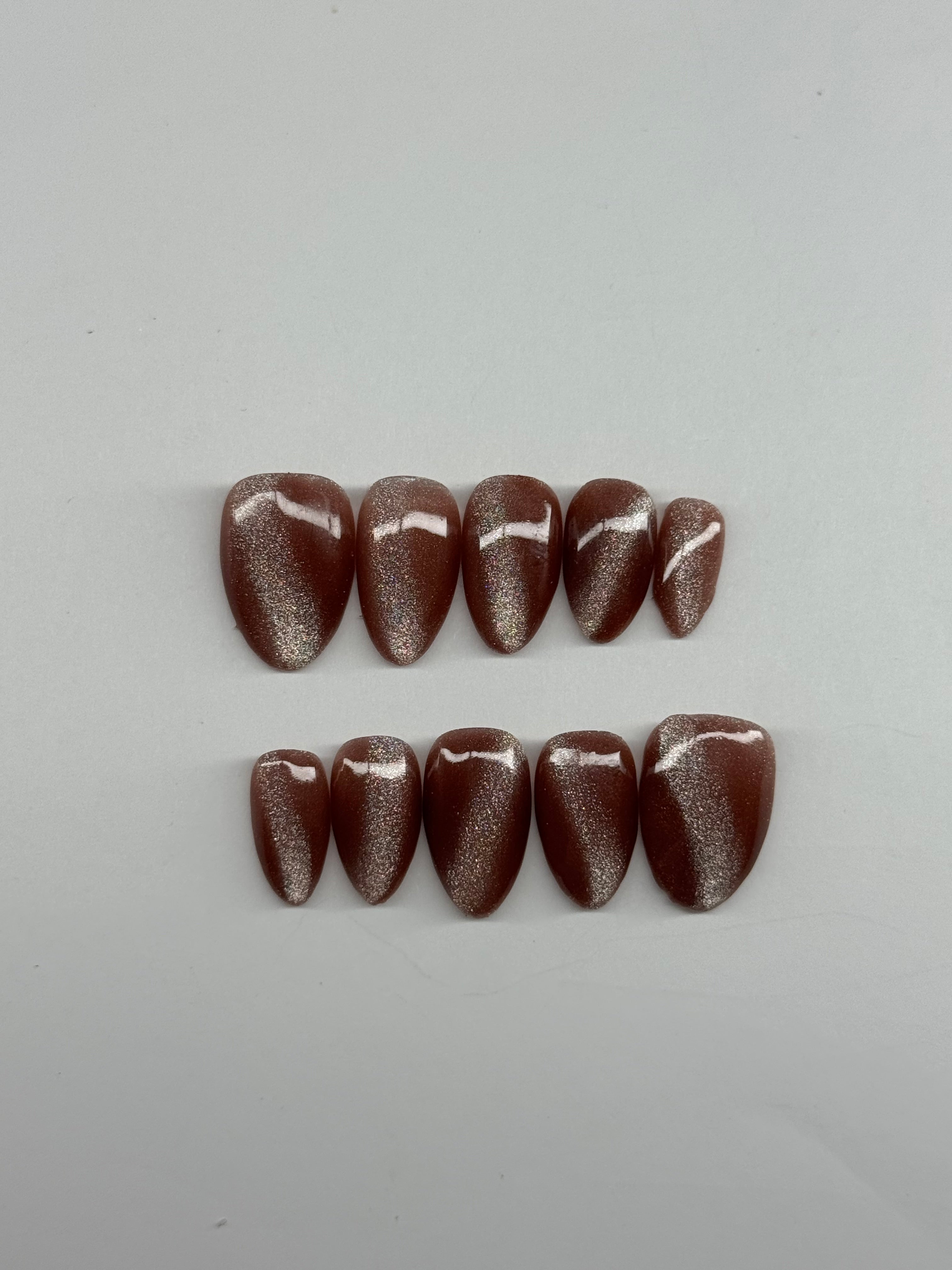 Two stacks of brown stones on a white background