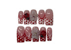 Set of red and white polka dot nail art designs on a white background
