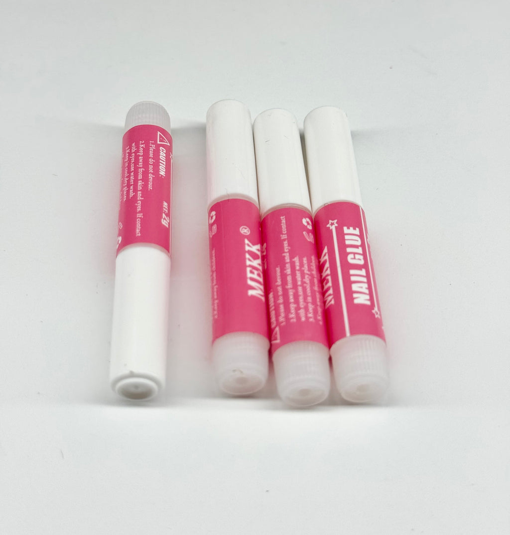 Four tubes of nail glue with pink caps on a white background