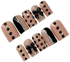 Set of nail art designs with black polka dots and bows on a beige background