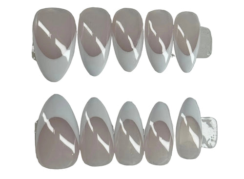 Set of clear nail extensions on a gray background