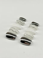 Silver ring with wavy design on a white background