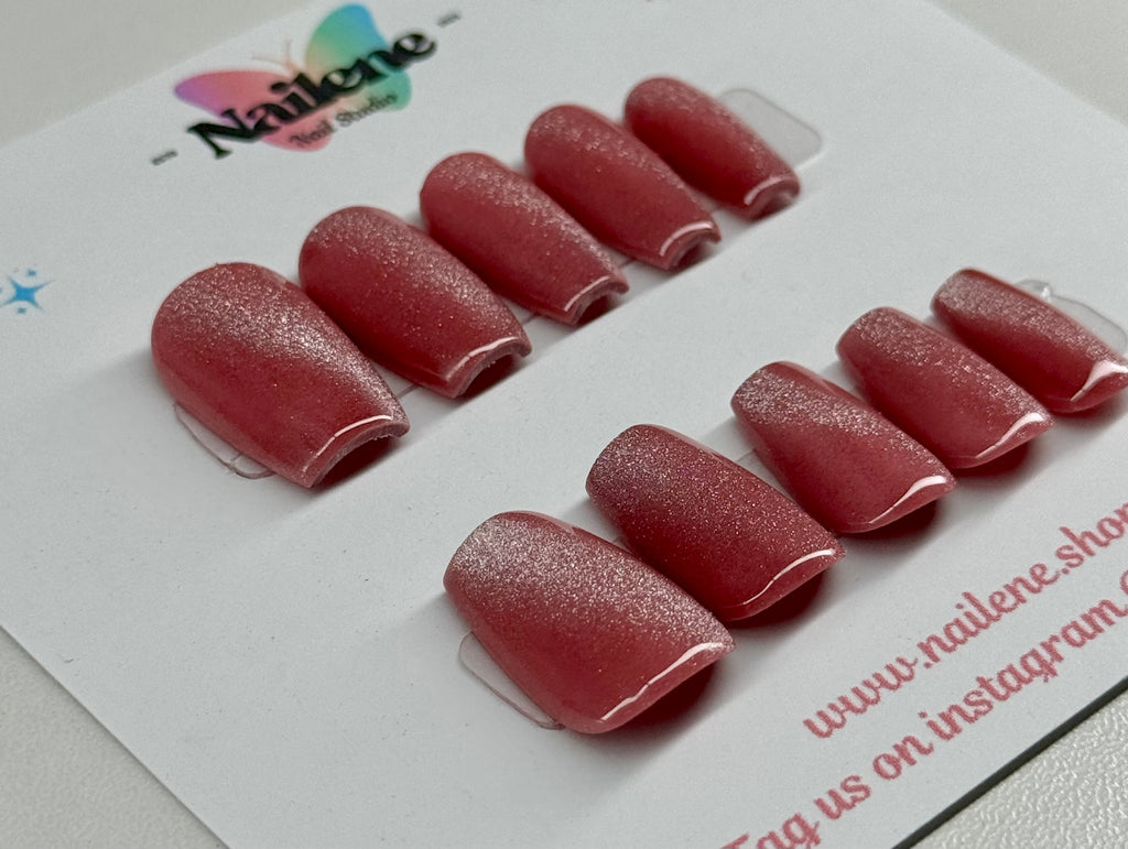 Set of cat eye nail tips on a white backing with Nailene branding.