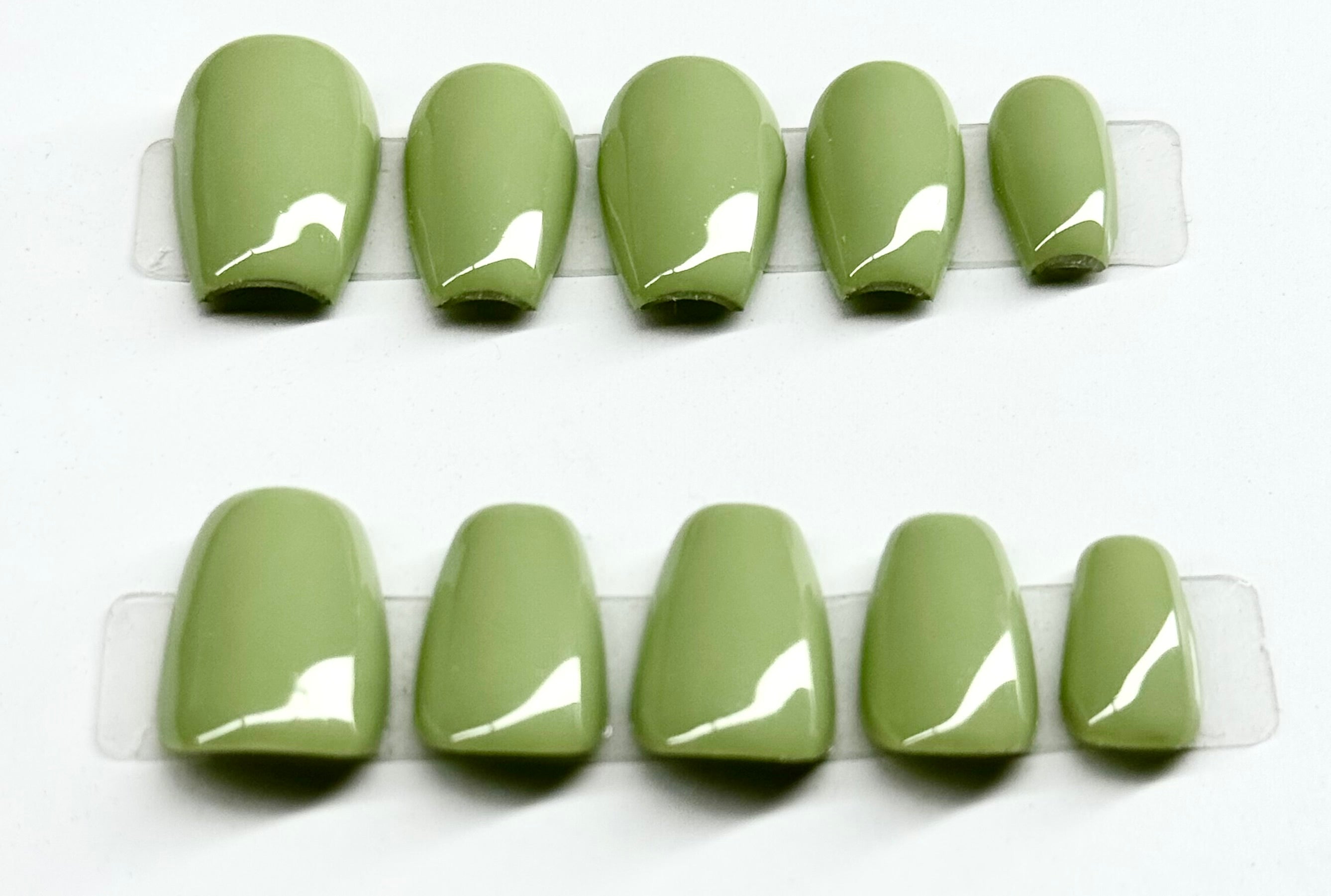 Set of green nail tips on a white background