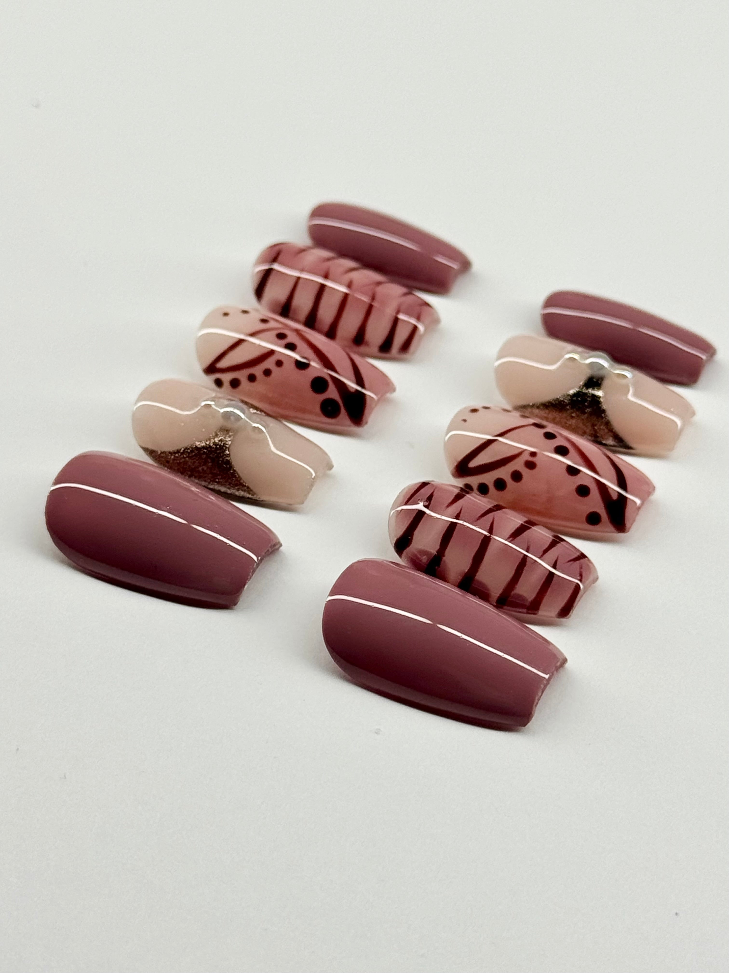Set of decorative false nails with patterns on a light gray background