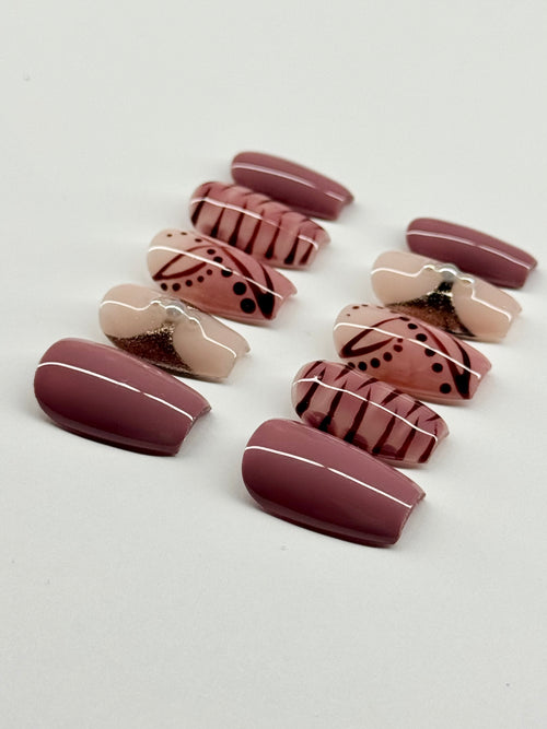 Set of decorative false nails with patterns on a light gray background