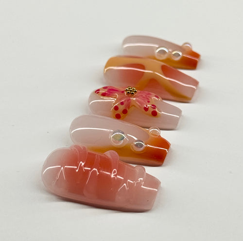 Set of decorative glass pieces with floral designs on a white background