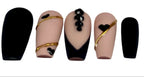 Set of nails with black and gold designs on a white background, featuring the Nailene Nail Studio logo.