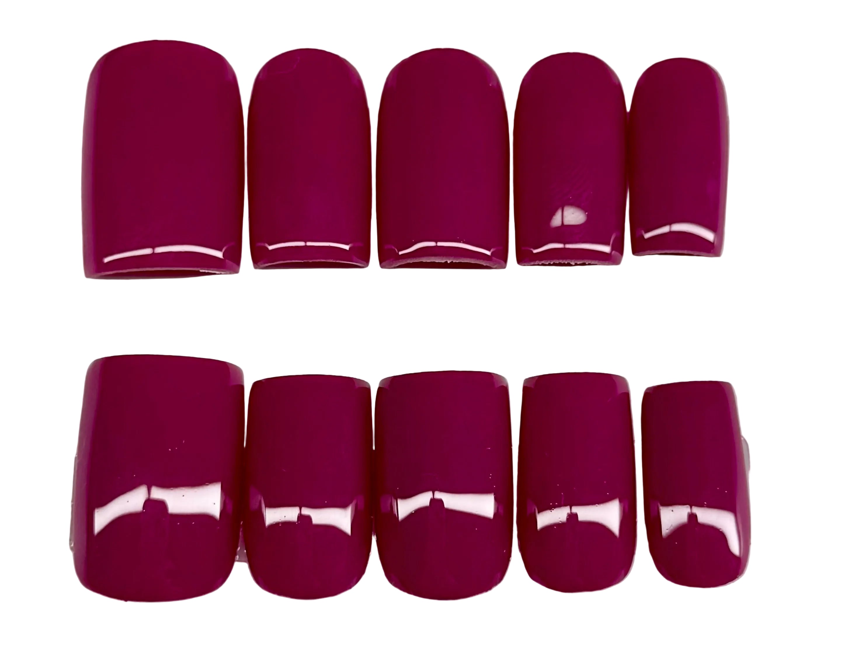 Set of plum solid color nail polish on a white background