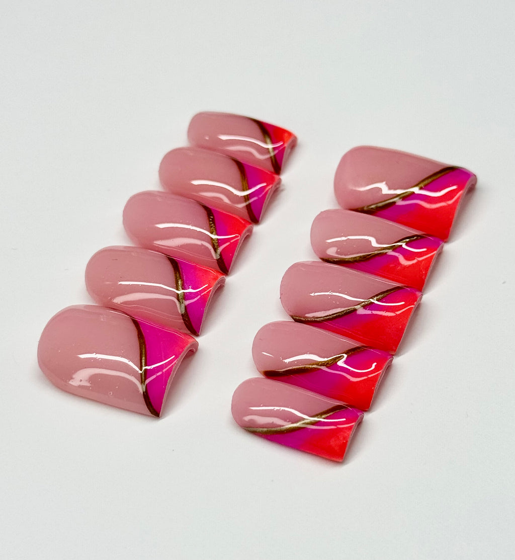 Pink and orange nail art designs on a white background