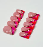 Pink and orange nail art designs on a white background