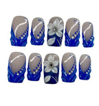 Set of nail art designs with blue, and white colors on a gray background