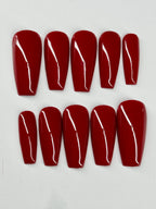 Set of red nail extensions on a white background