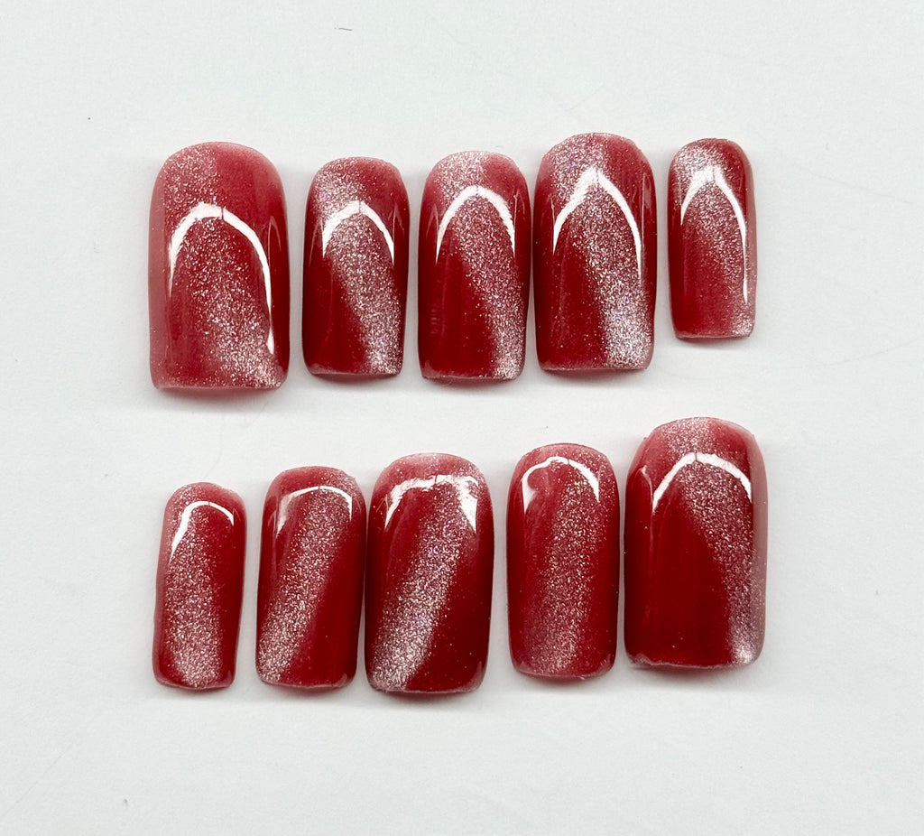 cat eye nail polish with white designs on a white background