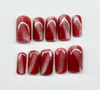 cat eye nail polish with white designs on a white background