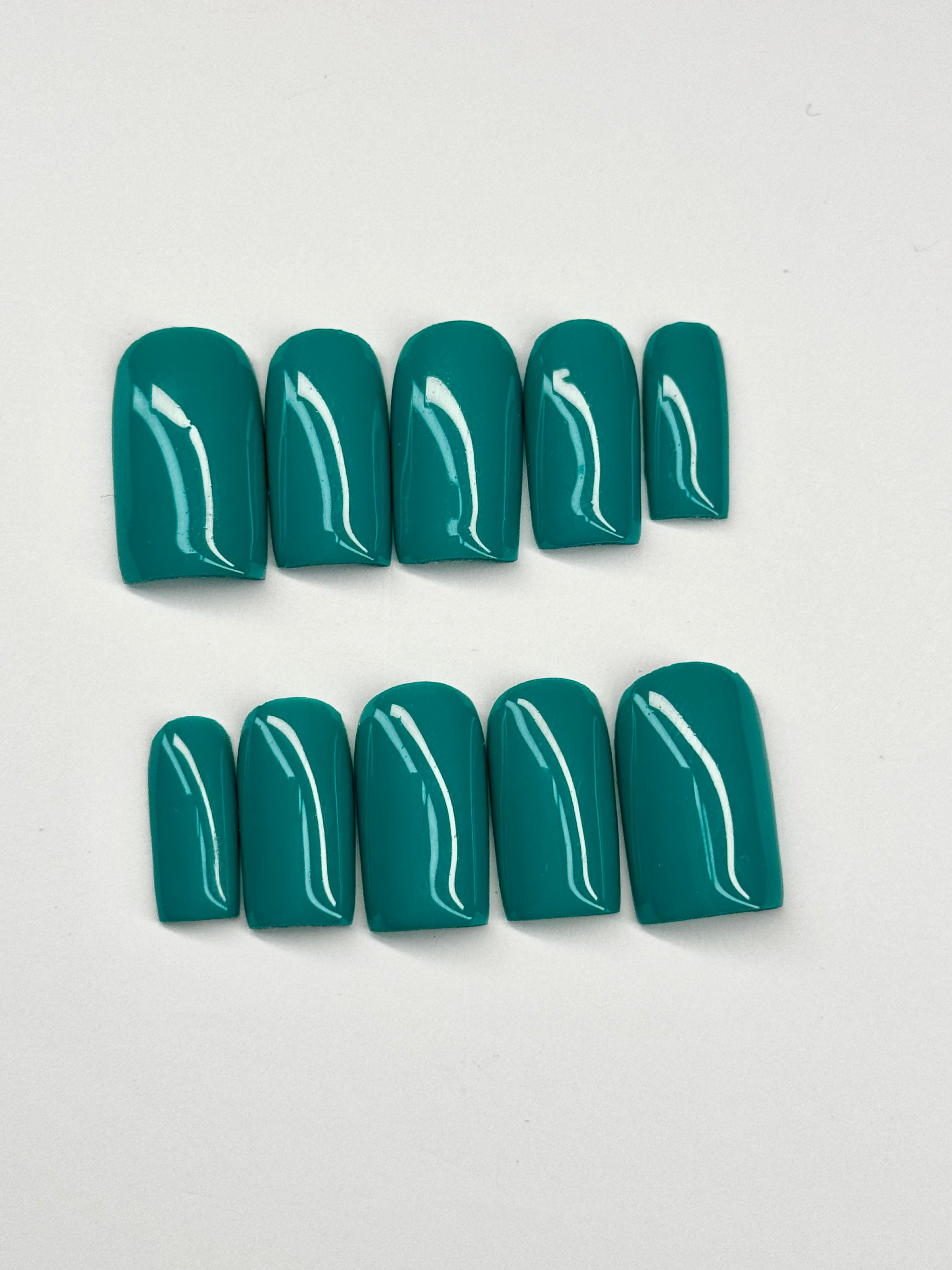 Set of teal nail polish on a light gray background