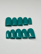 Teal nail polish strips on a light gray background